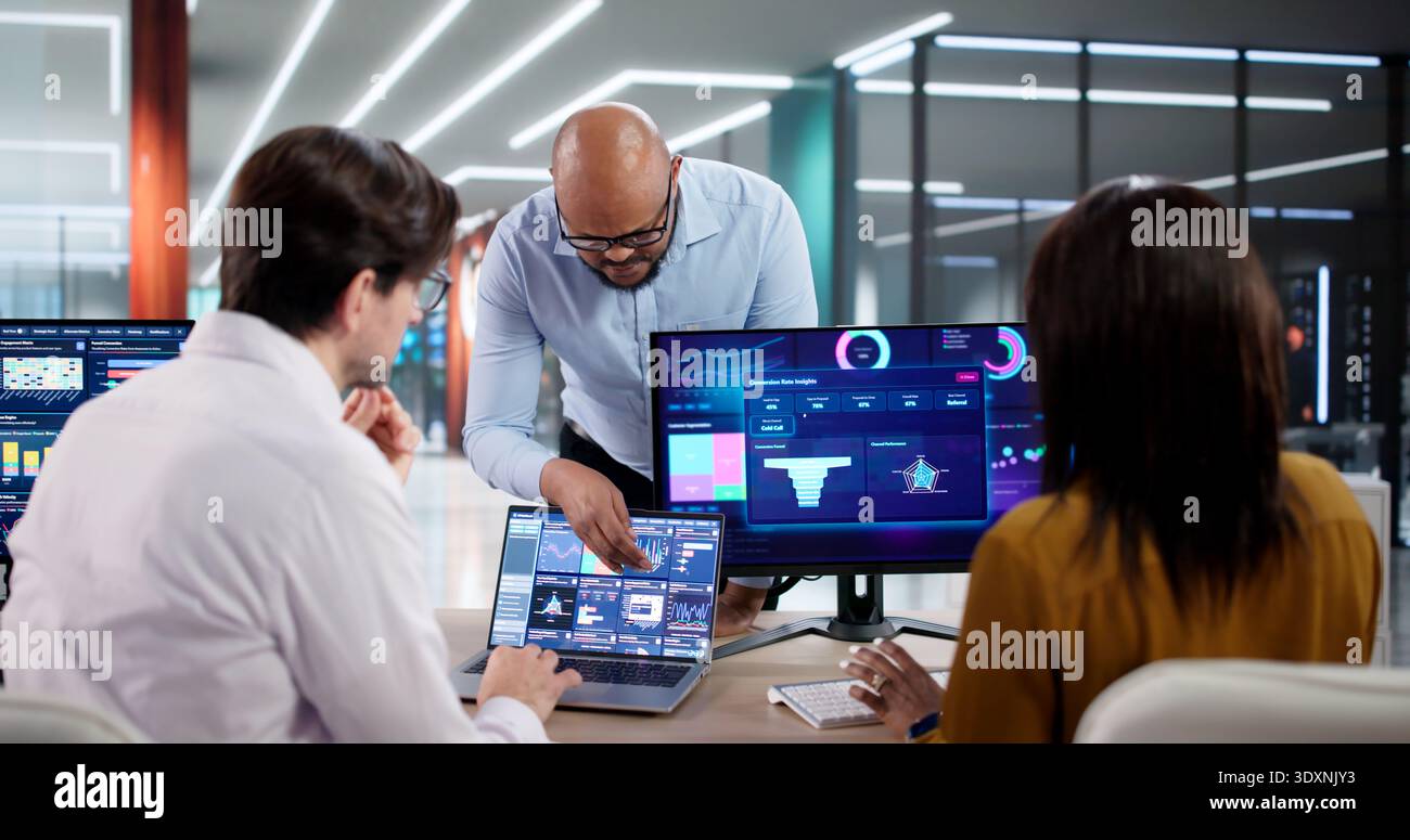 In A Modern Office, Diverse Team Collaborates Using Data Analytics Tools, Discussing Customer Behavior Predictions Stock Photo