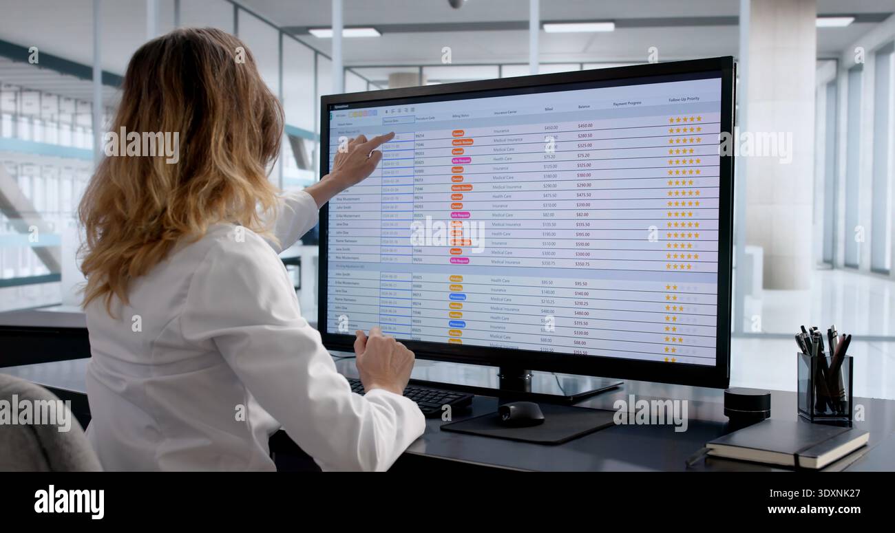 Female Chartered Accountant Analyzing Financial Data On Computer Spreadsheet Stock Photo
