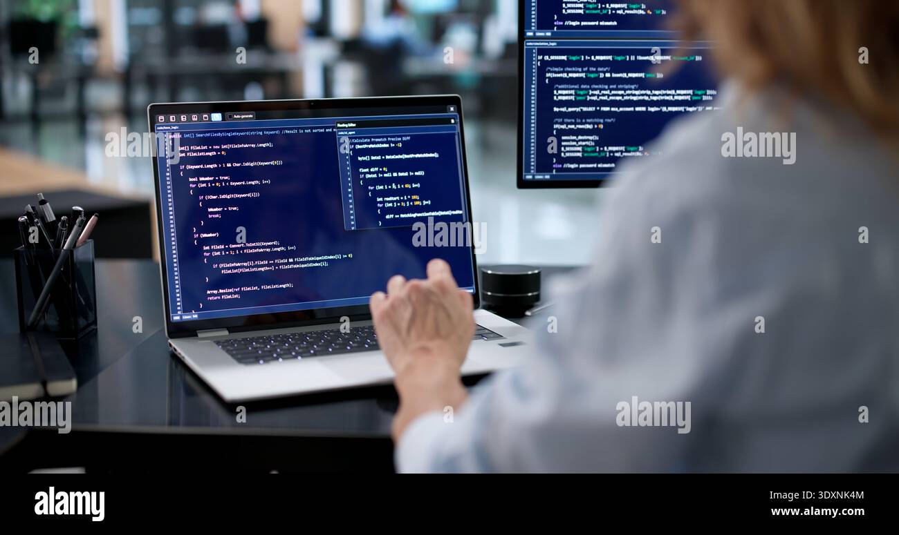 Female Engineer Creating Secure Software Code On Laptop Screen Stock Photo