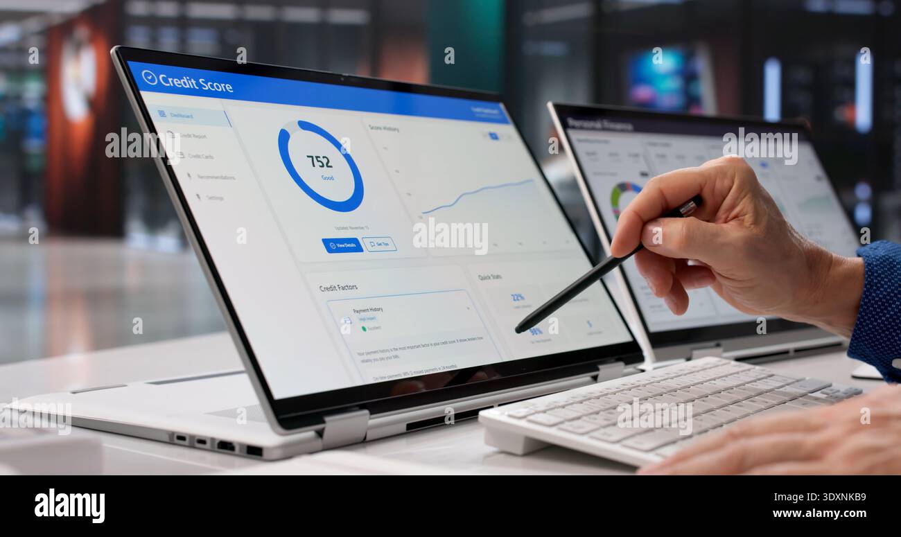 Businessman Analyzing Credit Score Online Using Laptop In Modern Office Stock Photo
