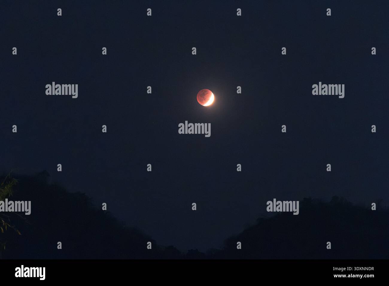 Mysterious total lunar eclipse, blood moon, glowing red in dark night ...