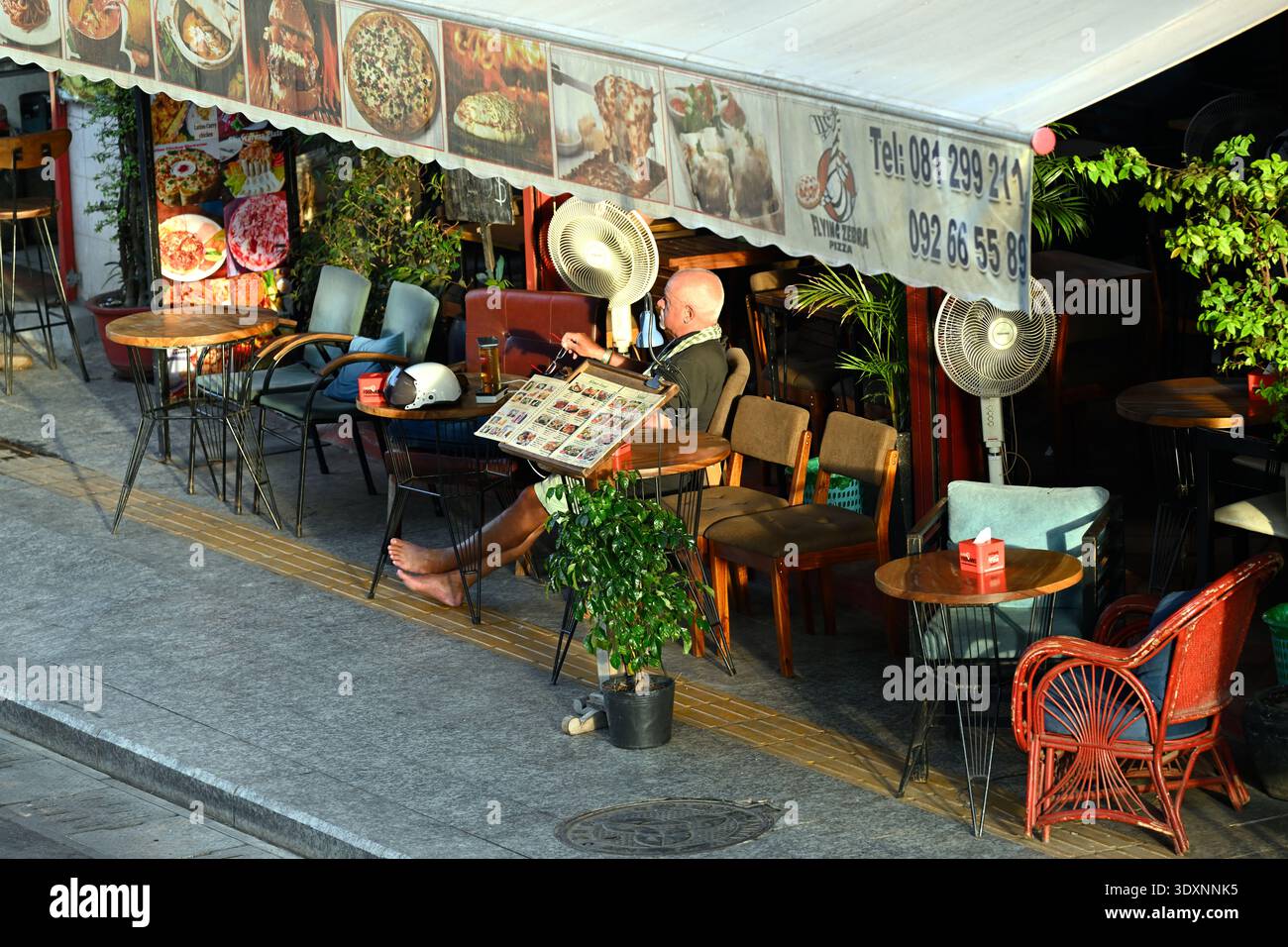 A Western man sits at a restaurant in Siem Reap, Cambodia. Stock Photo