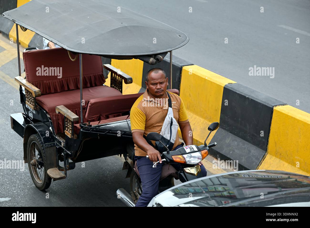 A Cambodian tuk tuk driver in Siem Reap, Cambodia. Stock Photo