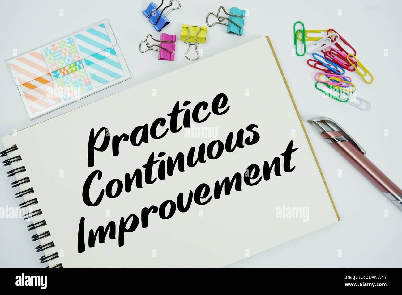 Practice Continuous Improvement text message written on notepad with stationery flat lay on white background Stock Photo