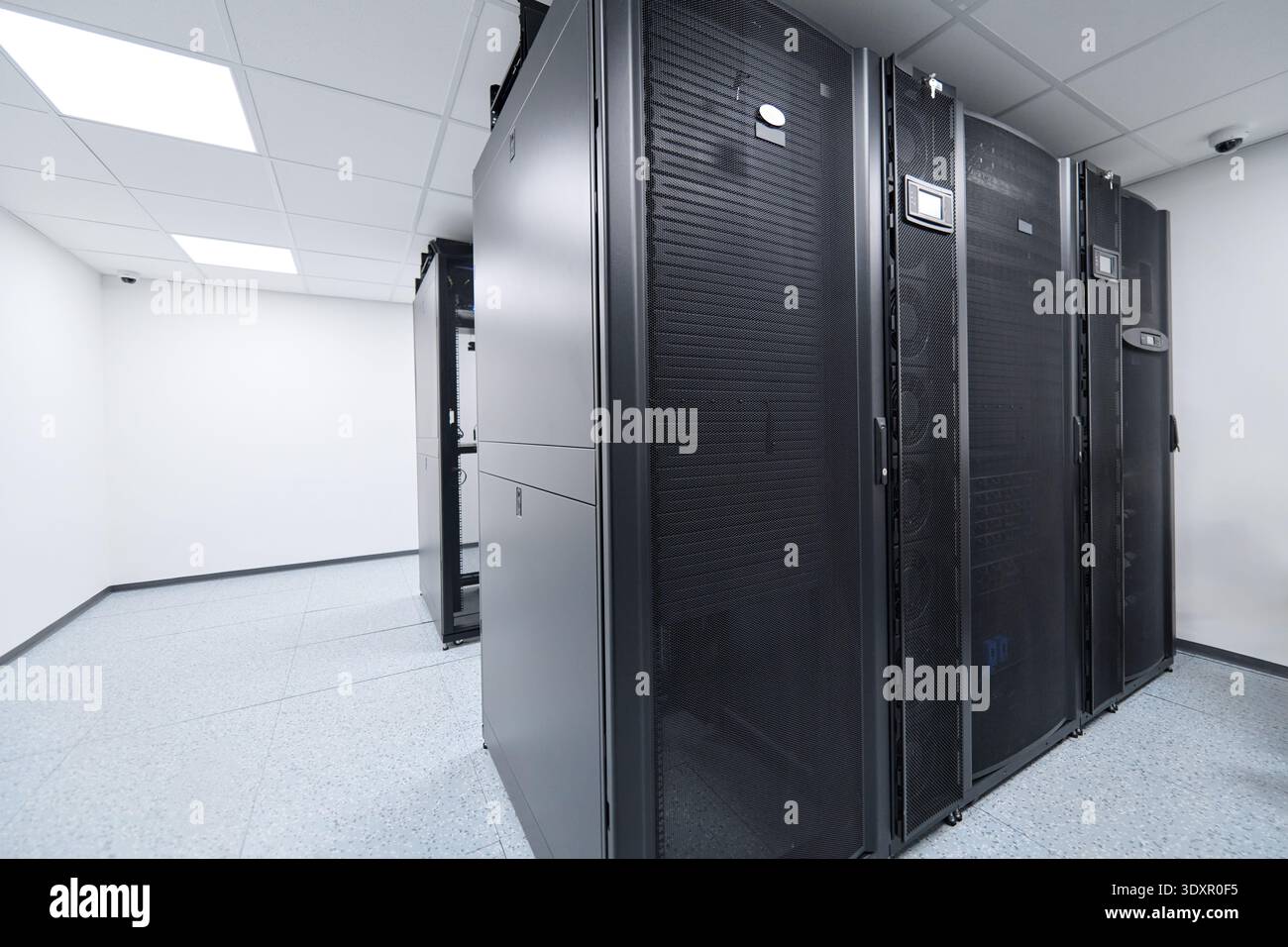 Modern data center server racks in a clean, climate-controlled server room for enterprise IT infrastructure Stock Photo