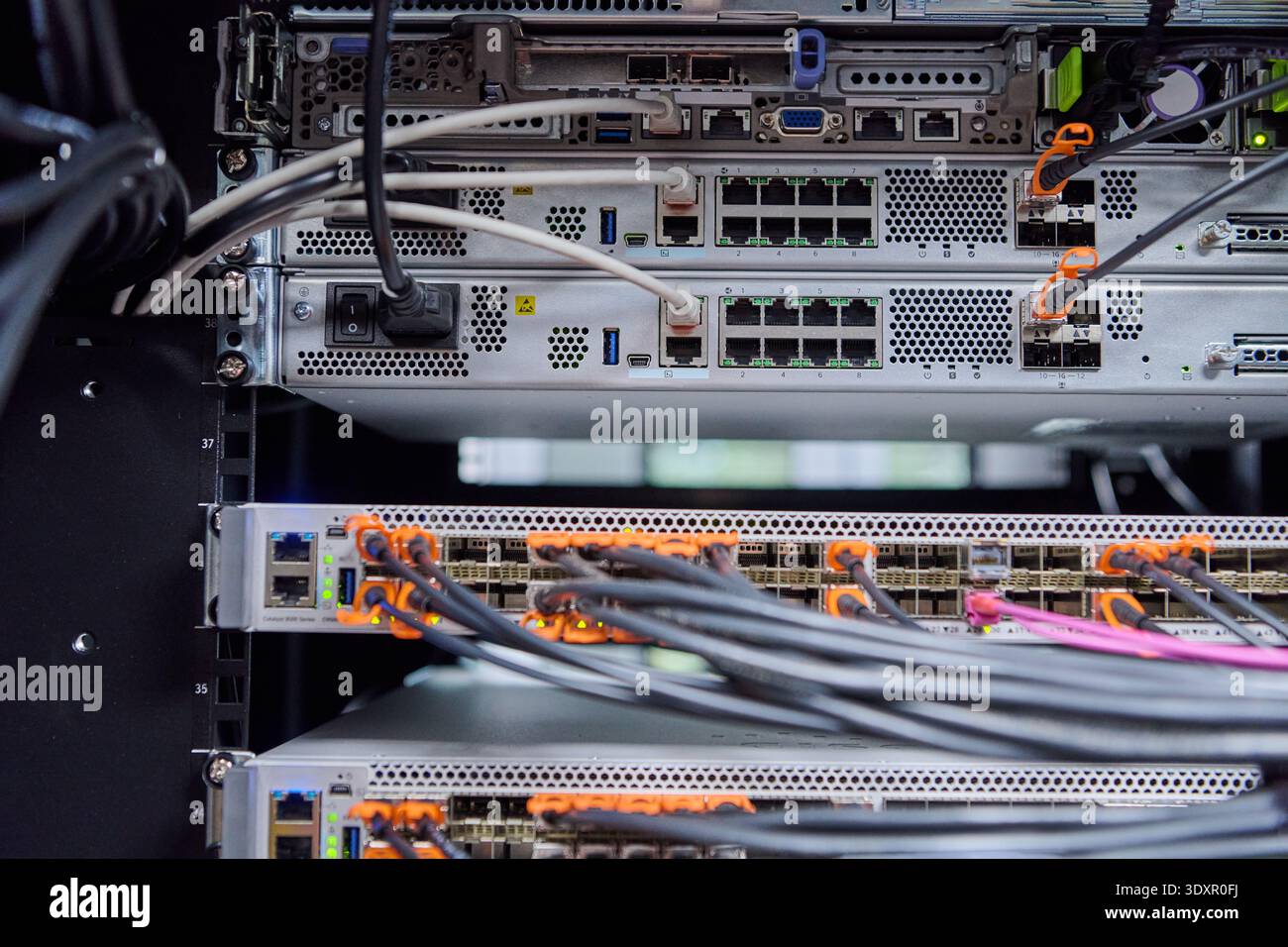 Network server rack with fiber optic cables and switches in a modern ...