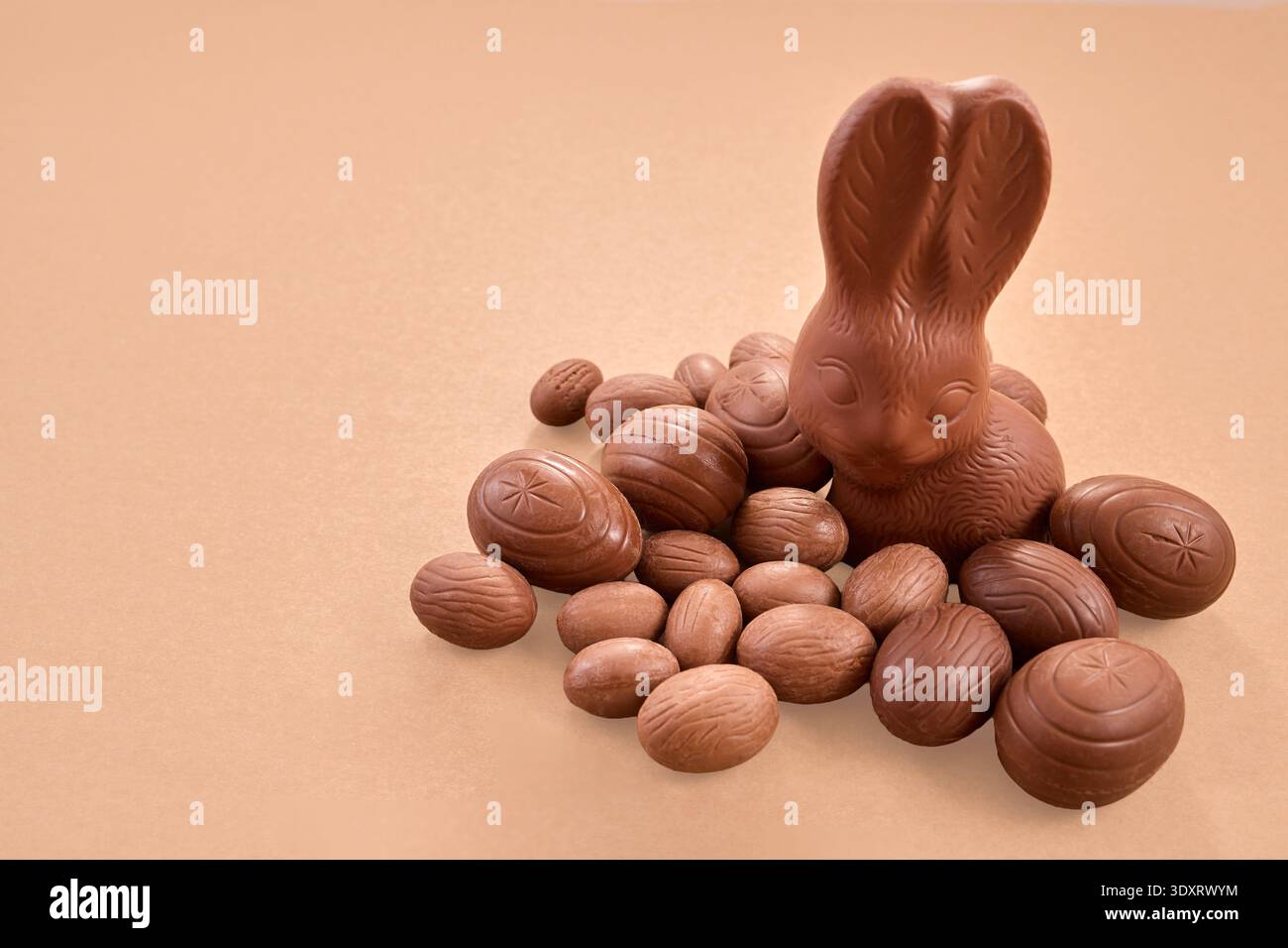 Chocolate easter bunny with sweet festive eggs Stock Photo