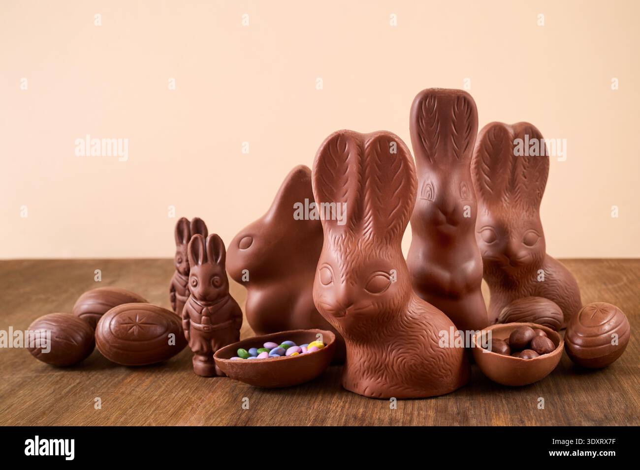 Chocolate bunnies and easter eggs on wood surface Stock Photo