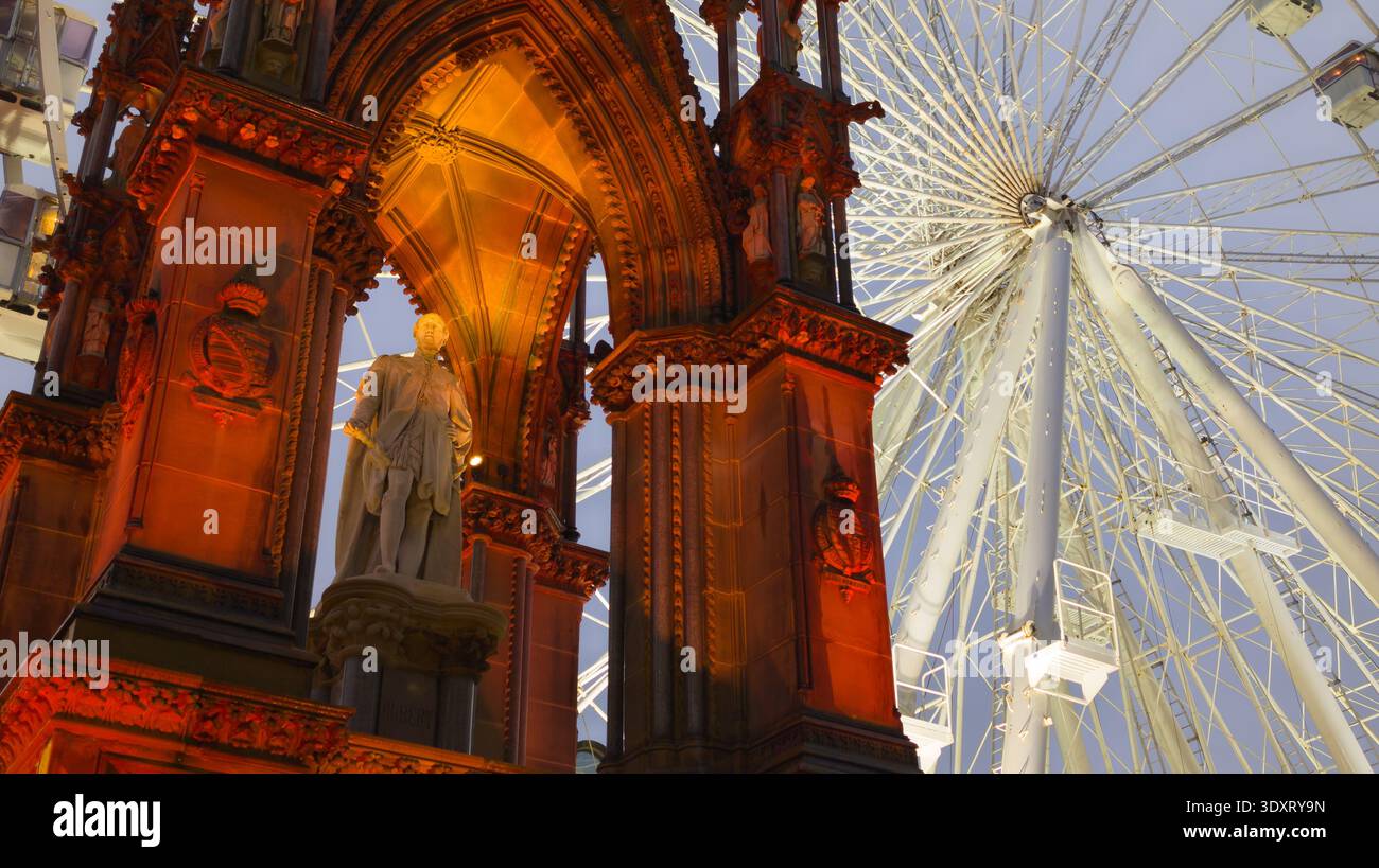 Statue of Prince Albert in front of Manchester Town Hall with Ferris wheel in background during Christmas Market in Albert Square, Manchester UK Stock Photo