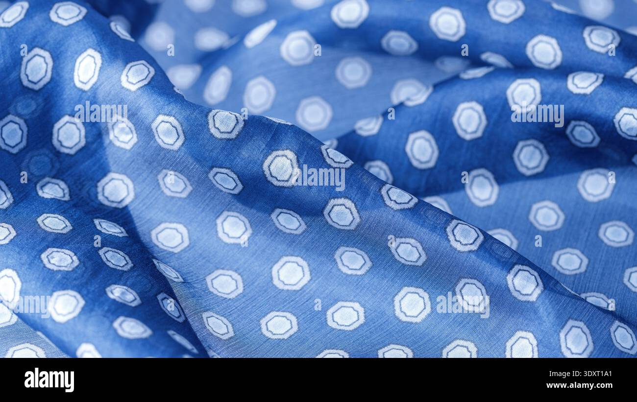 Abstract blue natural silk background. Silk fabric with polka dots pattern closeup. Stock Photo