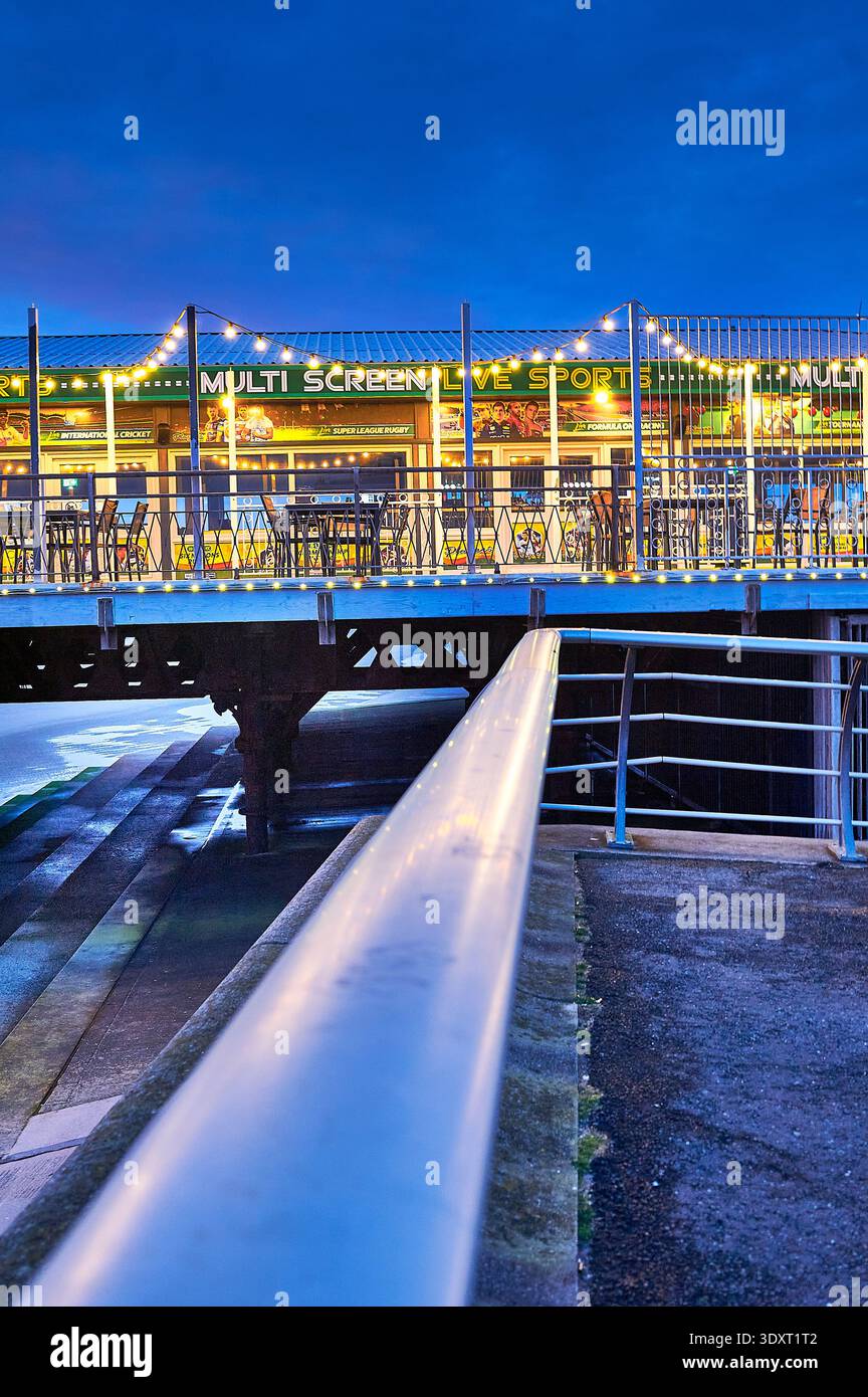 String of coloured light bulbs outside sports bar on South Pier,Blackpool,UK Stock Photo