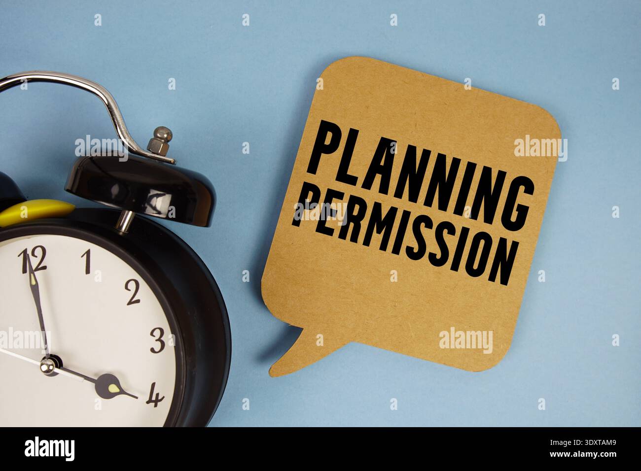 Planning Permission text with alarm clock on blue background Stock Photo