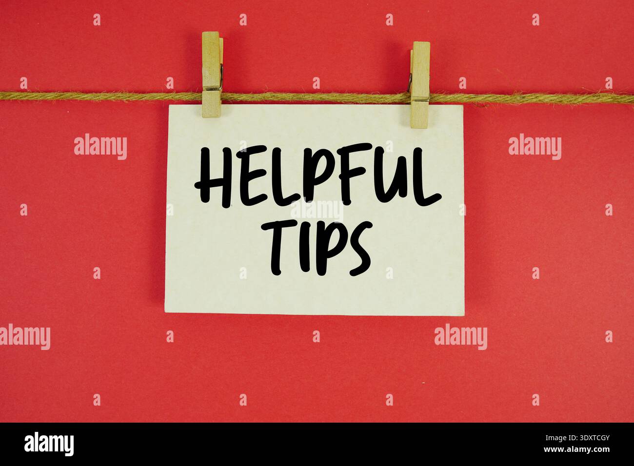 Helpful Tips paper notes hanging on the rope with clothespins Stock Photo