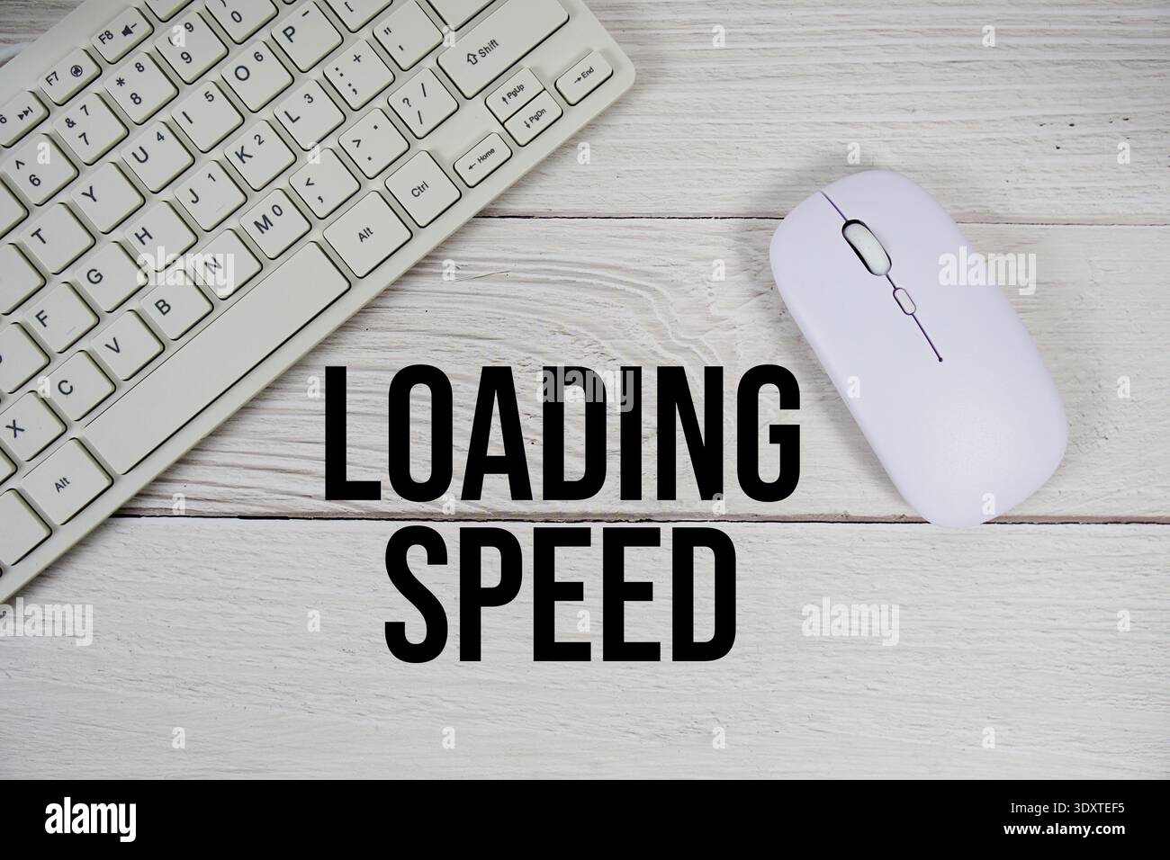 Loading Speed text with keyboard and wireless mouse on wooden background Stock Photo