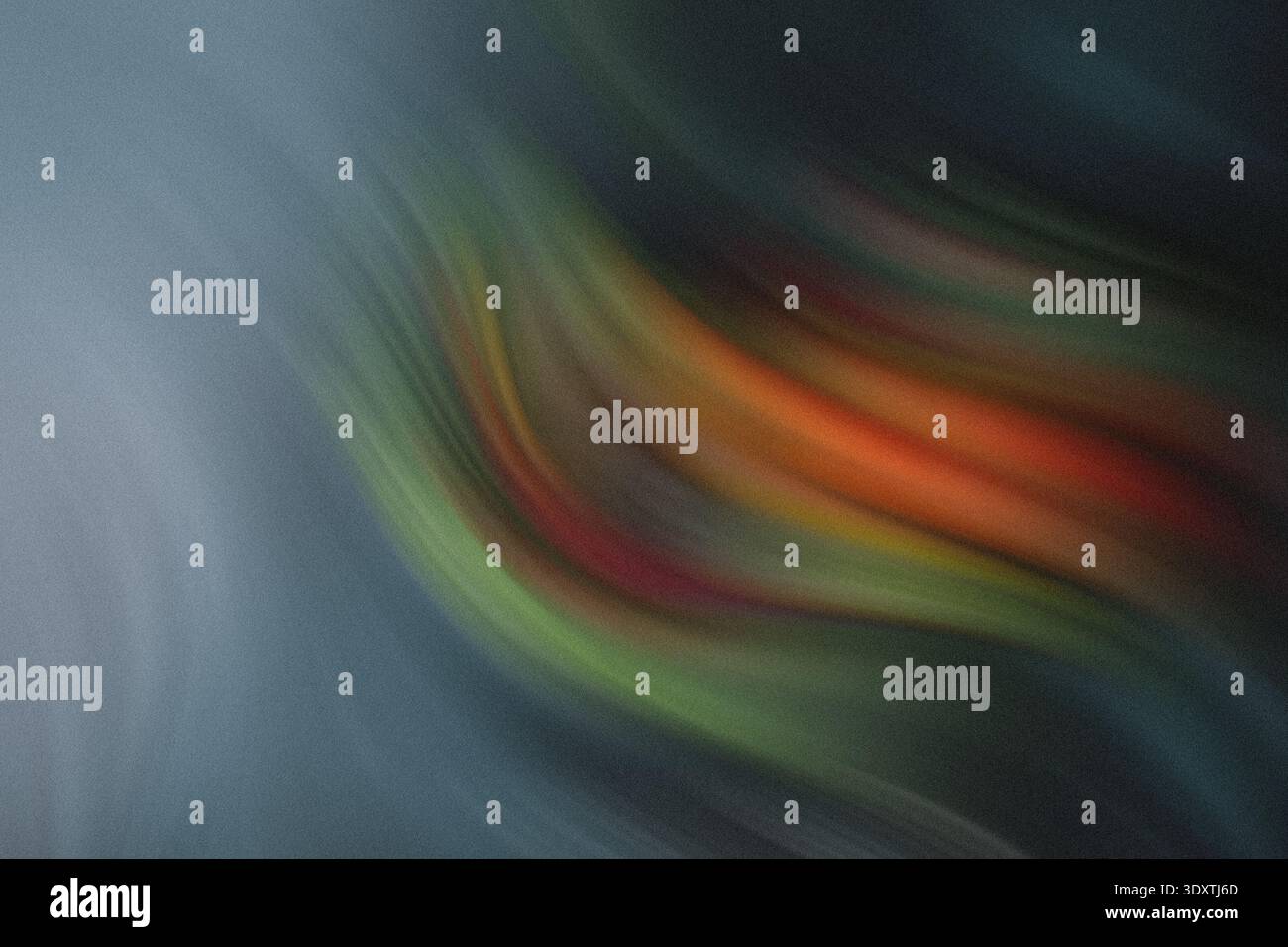 An abstract blurred image featuring a blend of colors including orange green and blue with soft transitions Stock Photo