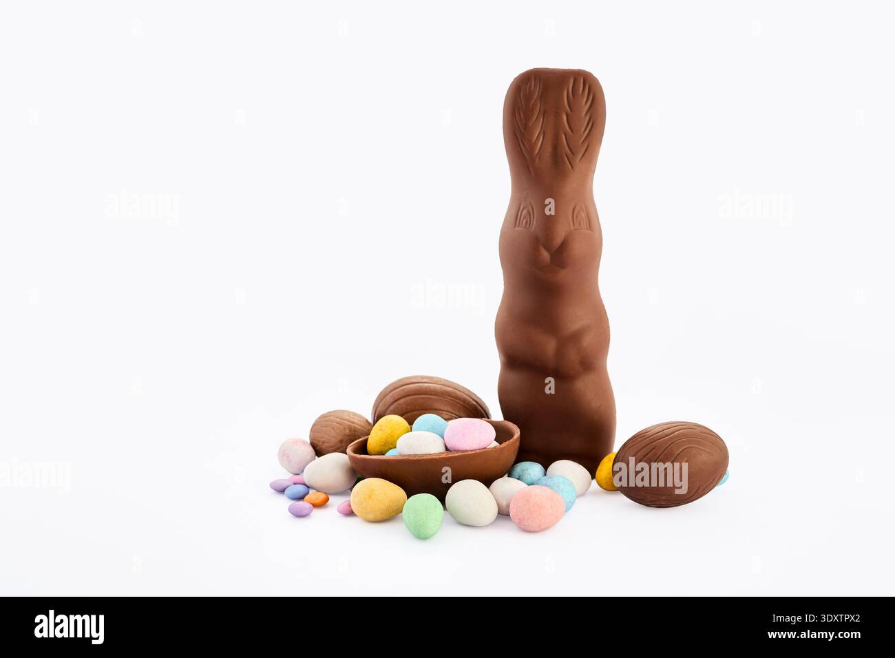 Chocolate easter bunny with decorated candy eggs Stock Photo