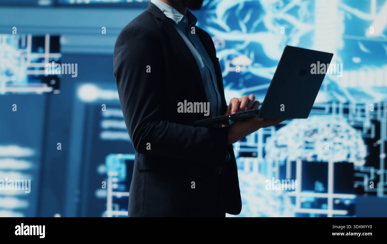 Young entrepreneur reviewing predictive analytics and machine learning algorithms. The digital interface reflects innovation, coding, AI ethics and platforms transformation. Camera A. Stock Photo