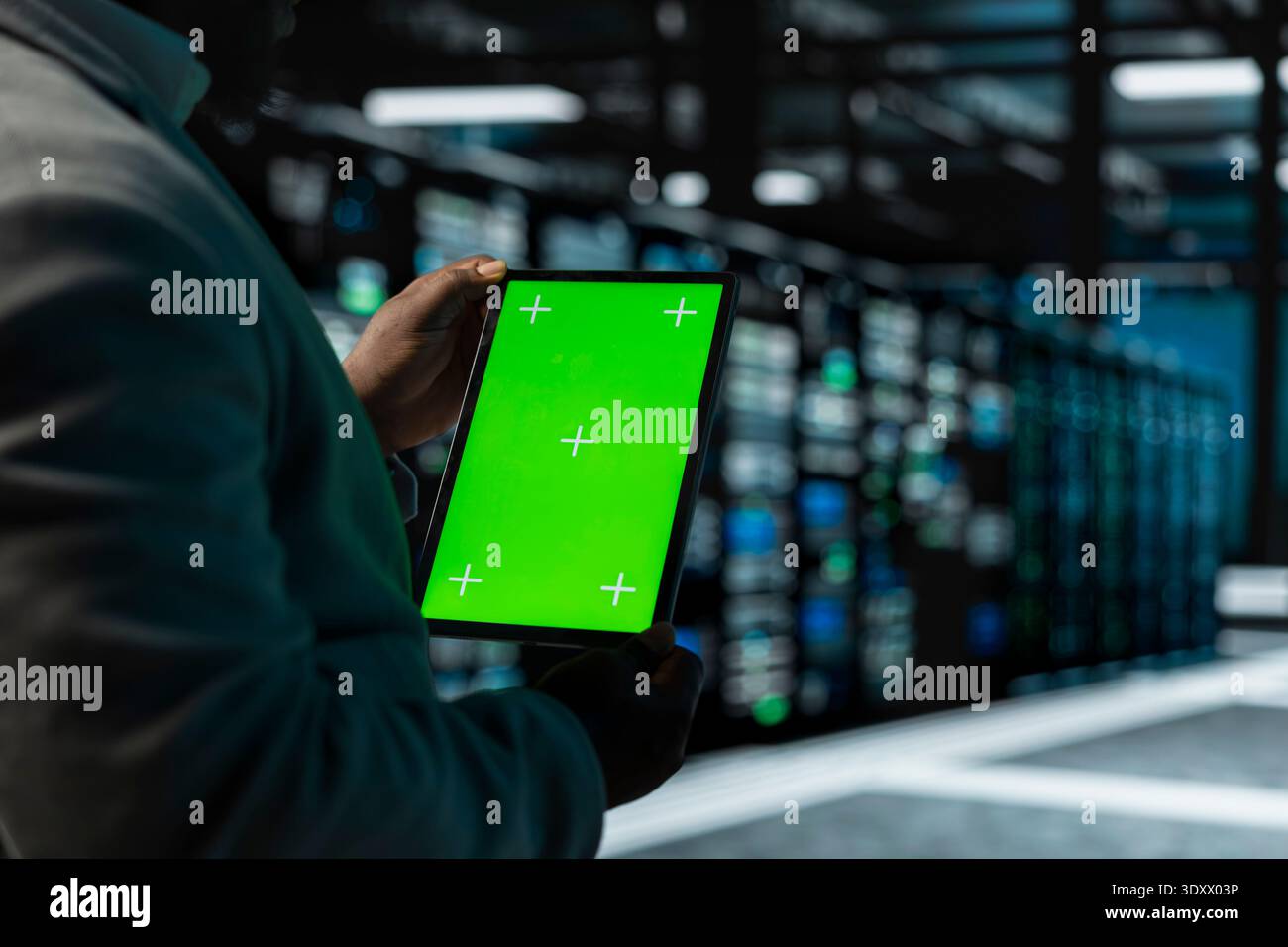 Close up of man in data center using green screen tablet to check for server performance issues. IT expert in server hub fixing errors slowing down hardware using chroma key device Stock Photo