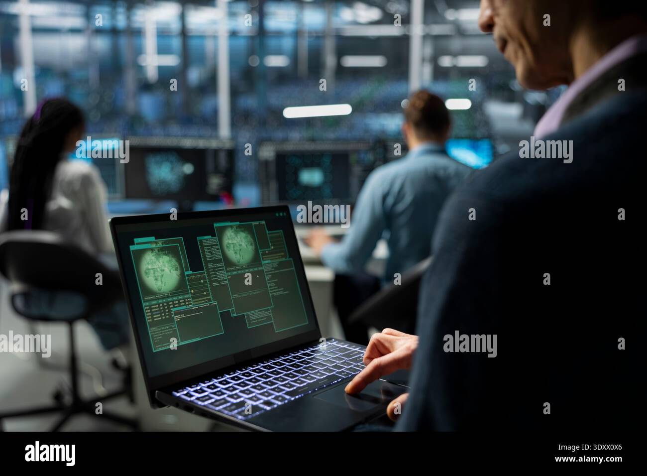 IT expert in server farm supporting international cloud services using notebook. Data center system administrator maintaining secure connectivity for global clients using laptop Stock Photo