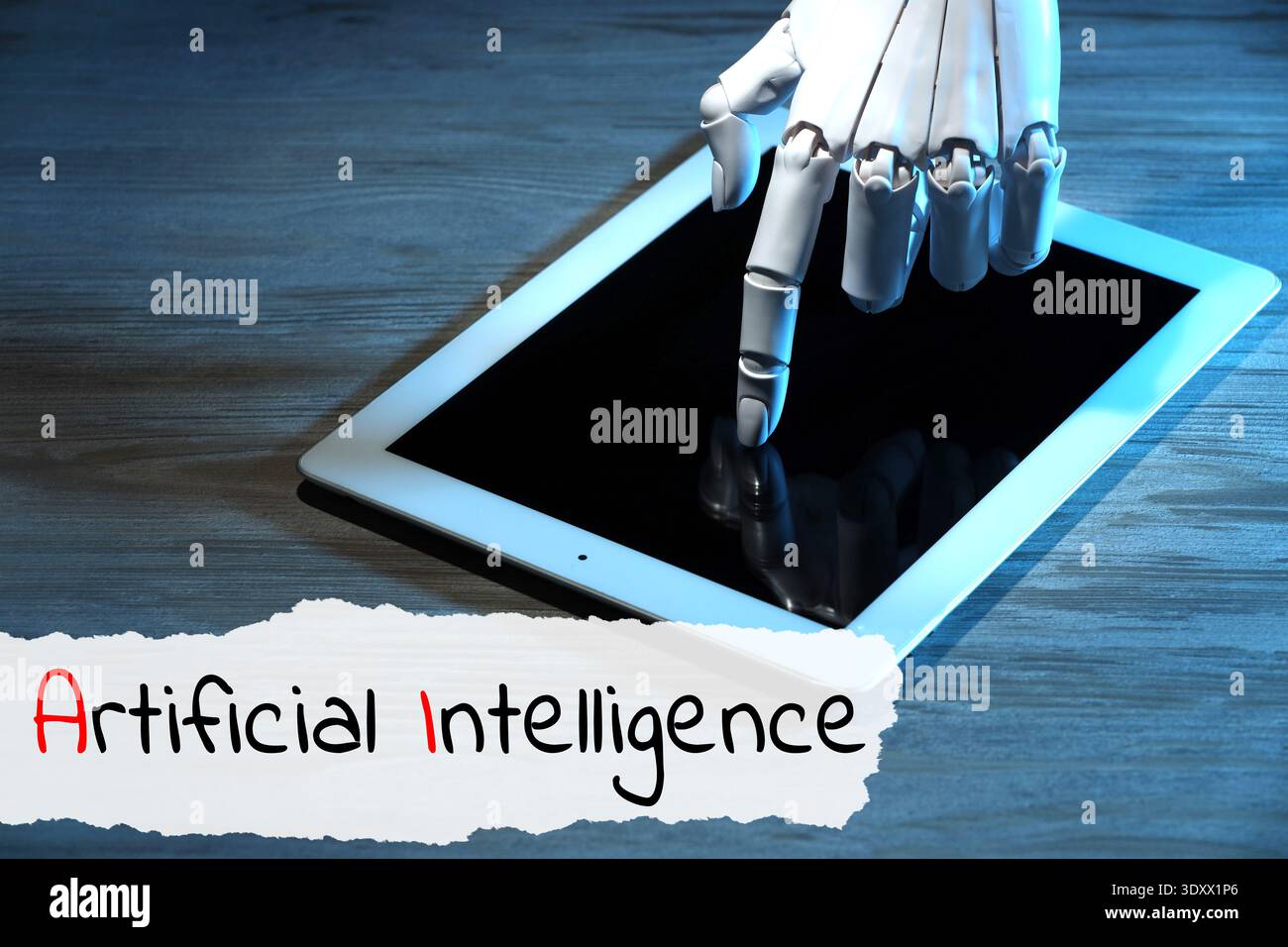 Robot using tablet computer. Text Artificial Intelligence on torn paper Stock Photo