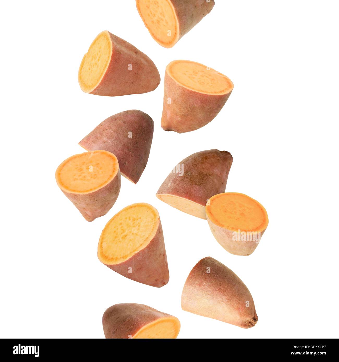 Sweet potato pieces falling against white background Stock Photo