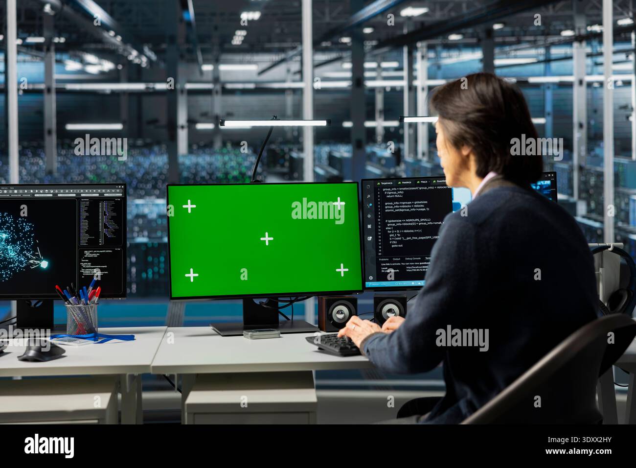 IT specialist using isolated screen PC in server room with infrastructure supporting data mining. Worker using mockup computer in data center to do maintenance on mainframes Stock Photo