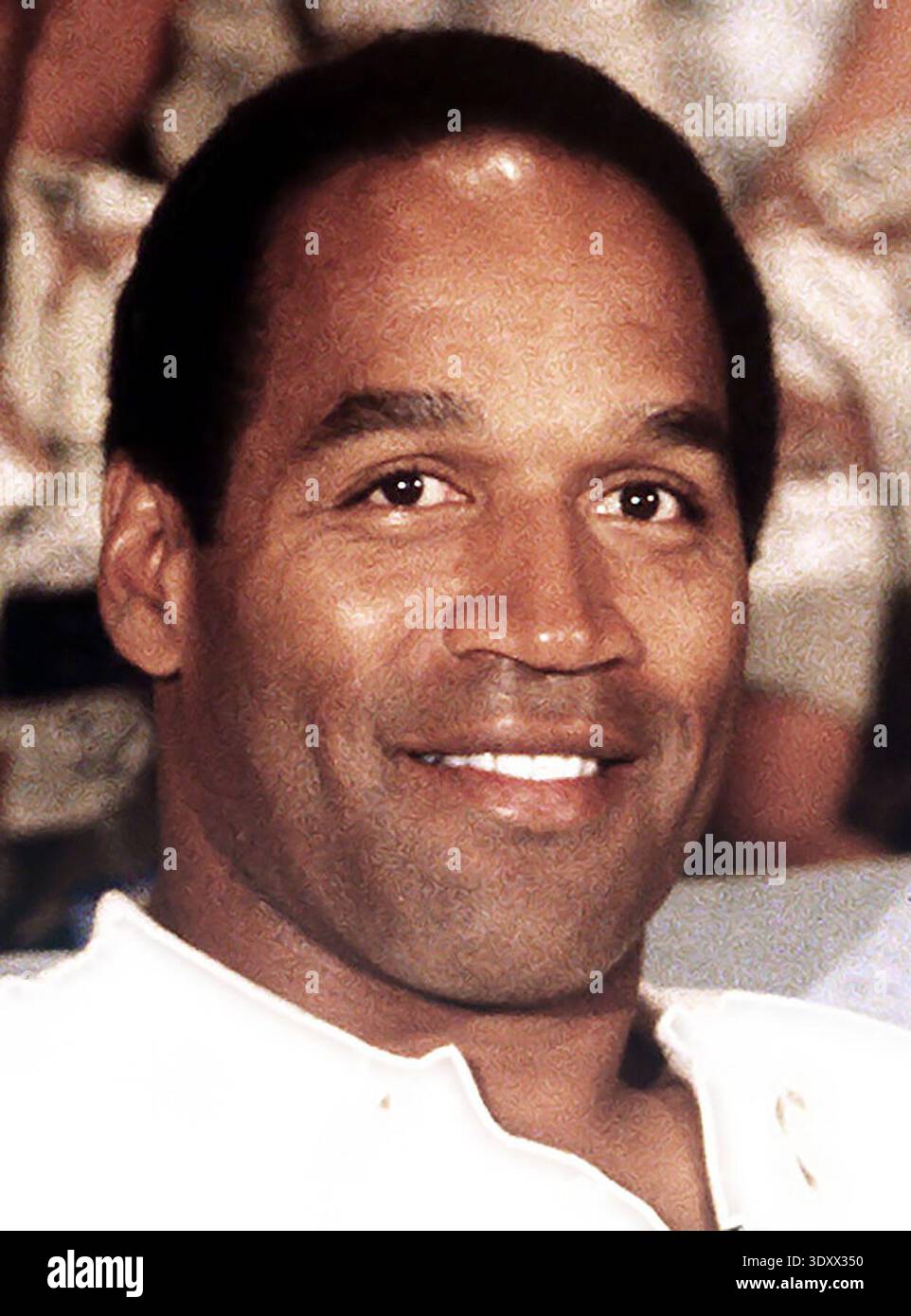 1990 NBC Sports commentator and former professional football player O. J. Simpson sits with a group of servicemen to watch a Thanksgiving Day football game. Simpson is visiting U.S. troops who are in the region for Operation Desert Shield. Stock Photo