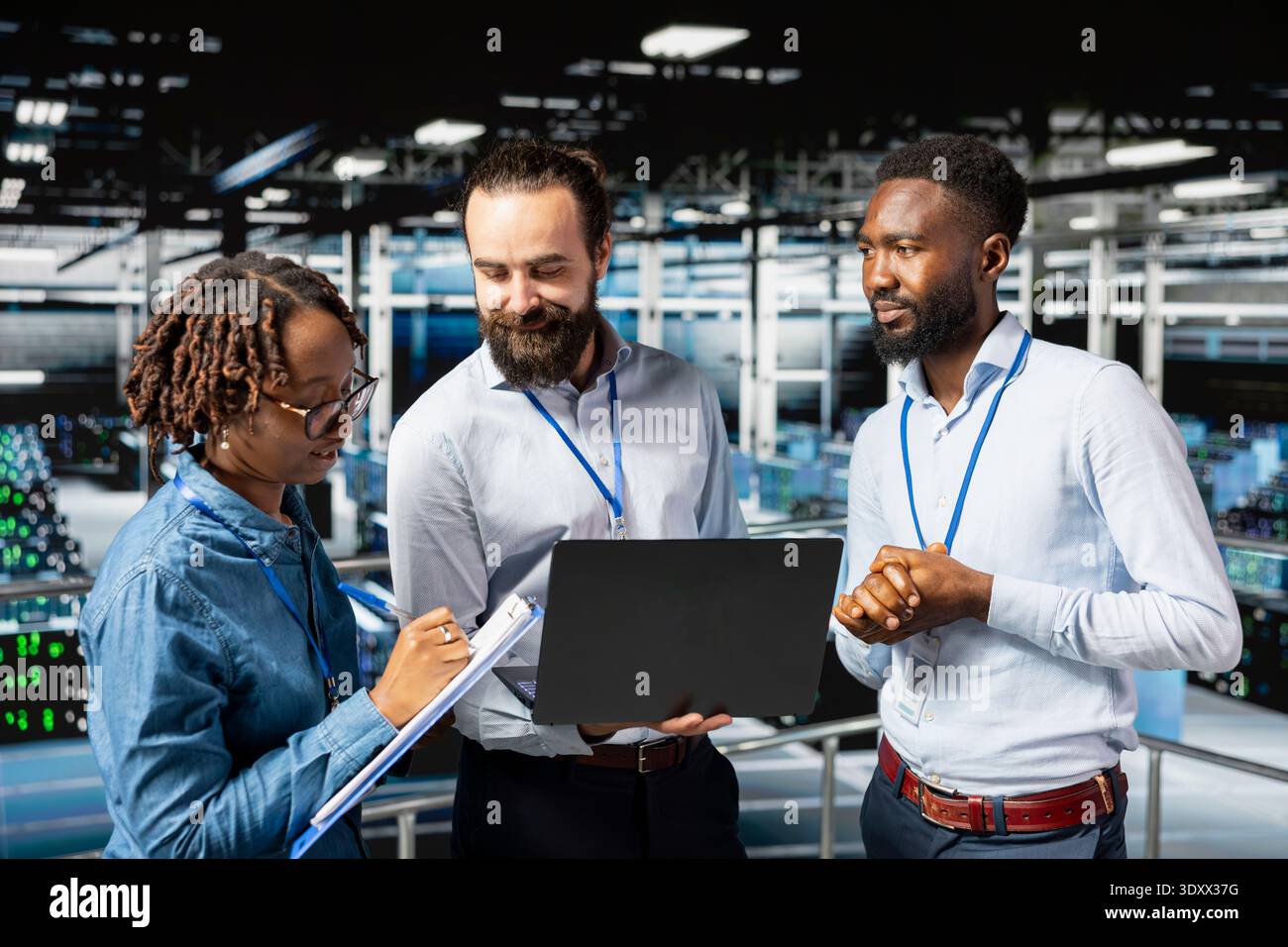 Multiethnic employees team collaborating on maintenance for server rigs and handling AI processing tasks. Data center engineering team supporting machine learning for software development. Stock Photo