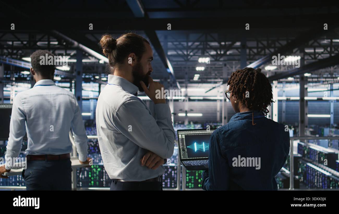 Data center manager overseeing work done by admin using neural network AI LLM visualization. Server farm team leader and worker overseeing rigs powering machine learning processes, Stock Photo