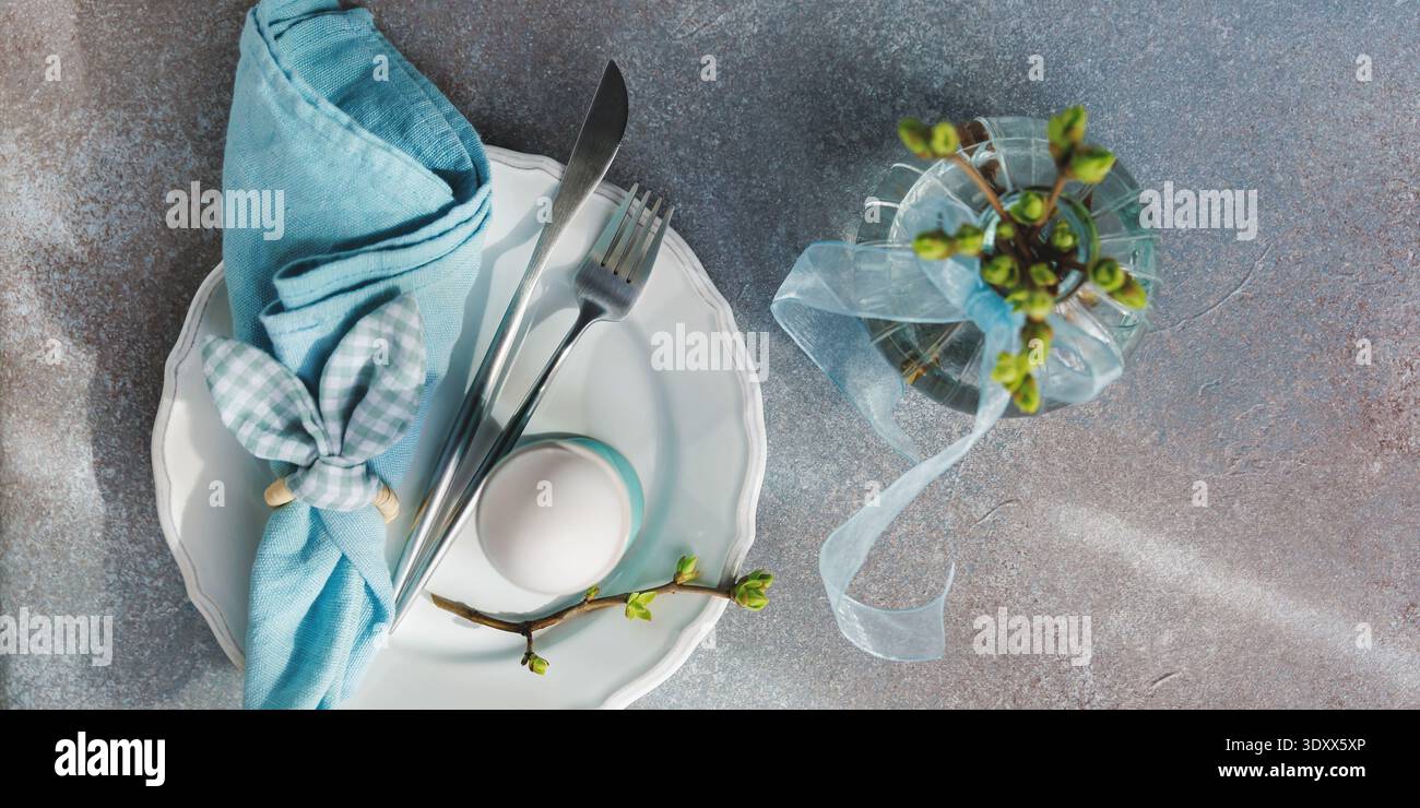 Easter Table Setting with Blue Napkin and Egg.. Stock Photo