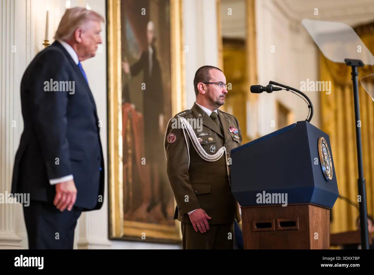 President Stand President Donald J. Trump stands beside a U.S. Army soldier at the ...