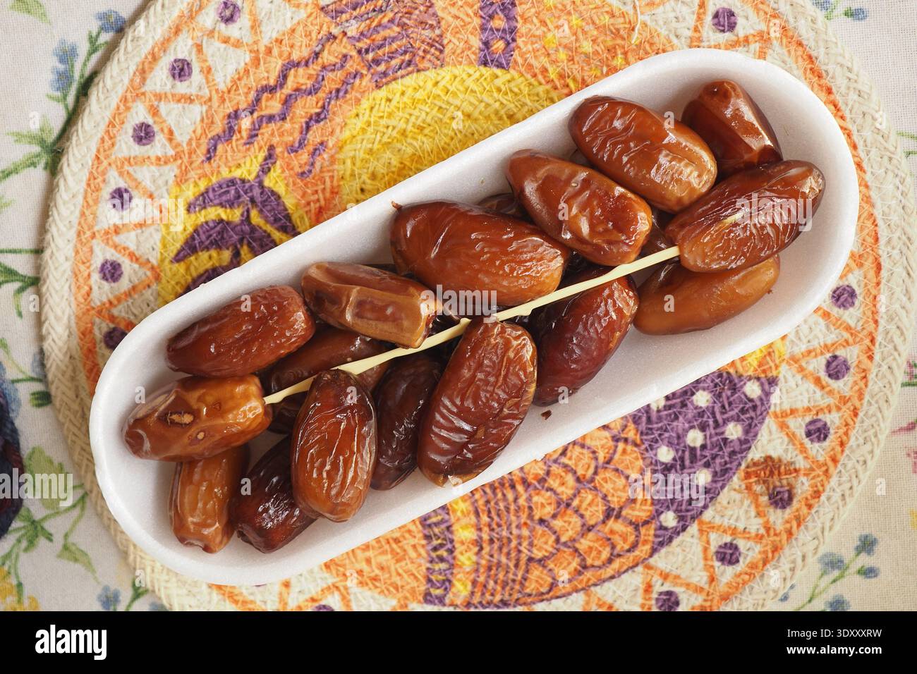 Fresh dates served on a plate during a meal Stock Photo