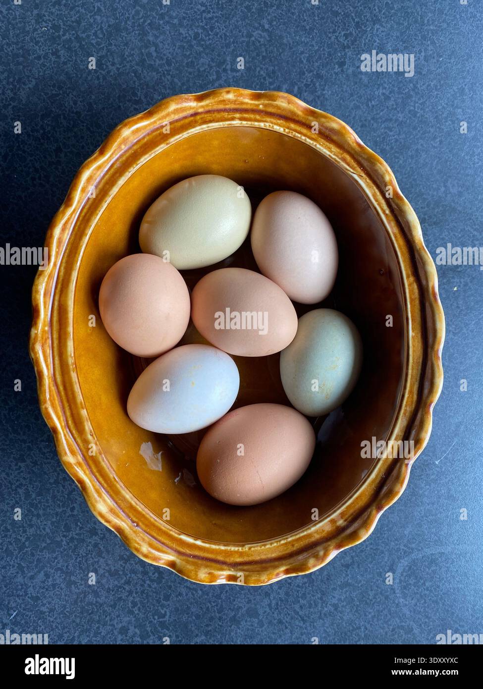 Multi Colored Farm Fresh Eggs in Ceramic Bowl Stock Photo