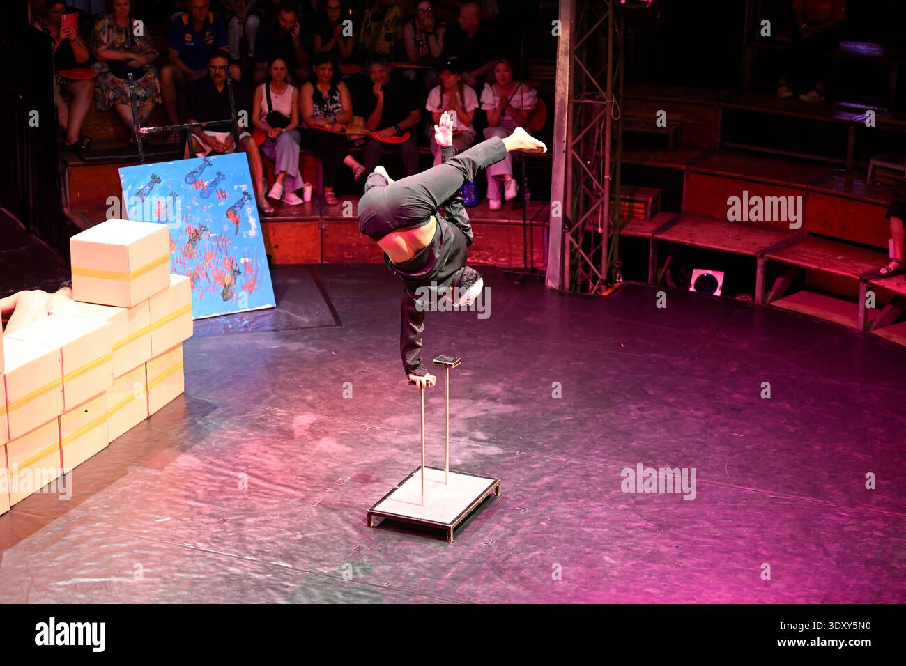 A circus acrobat performs a balancing act during the Phare circus production of Sokha in Siem Reap, Cambodia. Stock Photo
