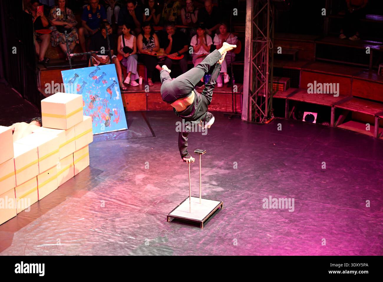 A circus acrobat performs a balancing act during the Phare circus production of Sokha in Siem Reap, Cambodia. Stock Photo