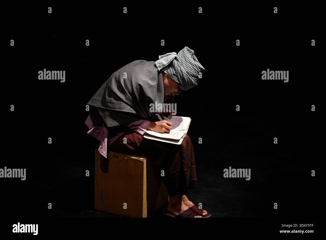 Lead character Sokha recalls her past from her memoir during the Phare circus show of the same name in Siem Reap, Cambodia. Stock Photo