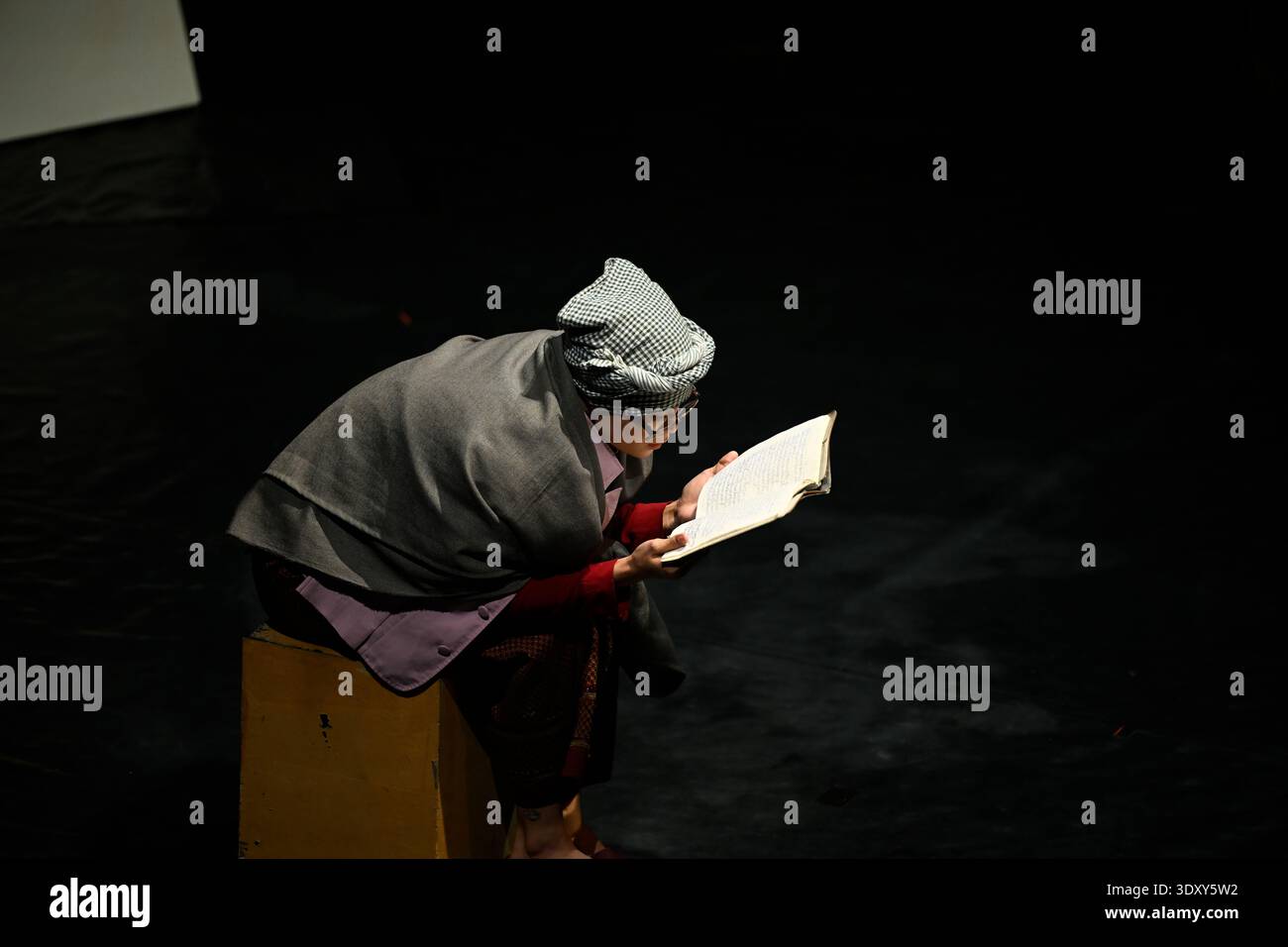Lead character Sokha recalls her past from her memoir during the Phare circus show of the same name in Siem Reap, Cambodia. Stock Photo