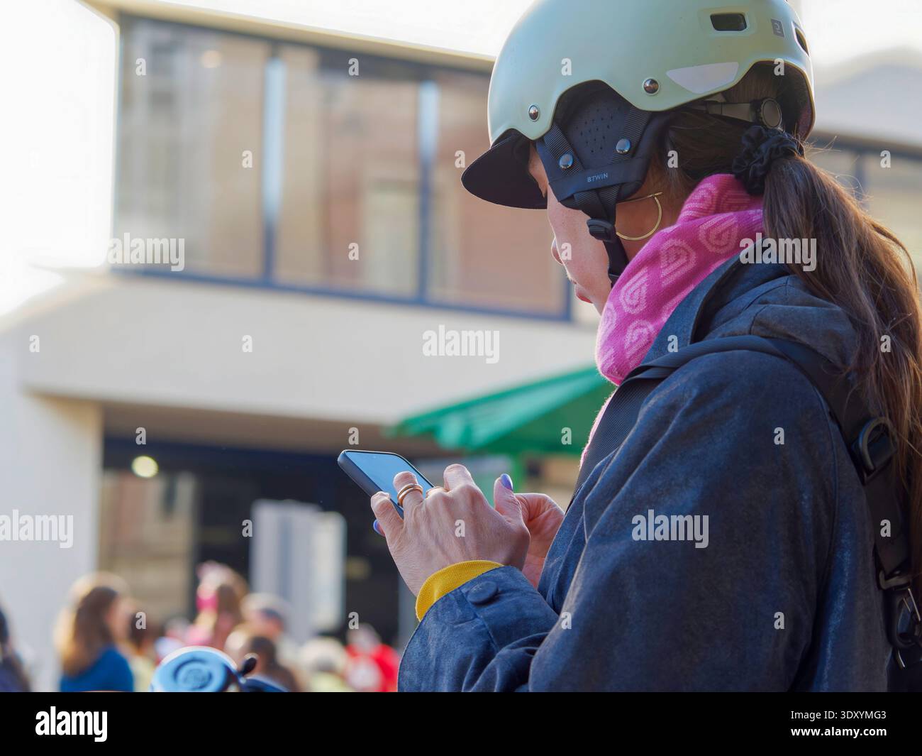 Young Woman in Cycling Gear Using Smartphone Outdoors Stock Photo