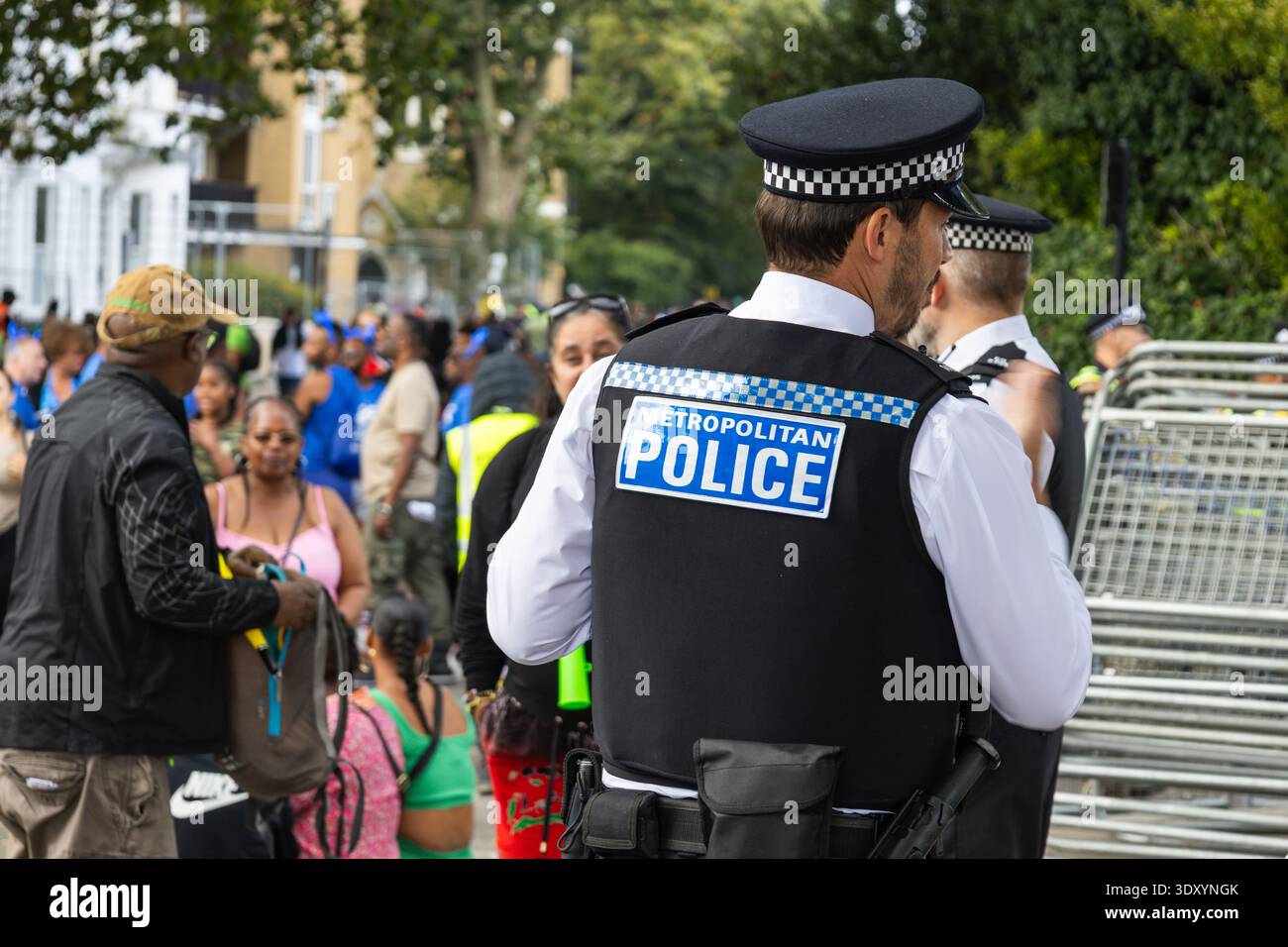 Police officer on duty at public event crowd control. London, UK, 25 August 2024 Stock Photo