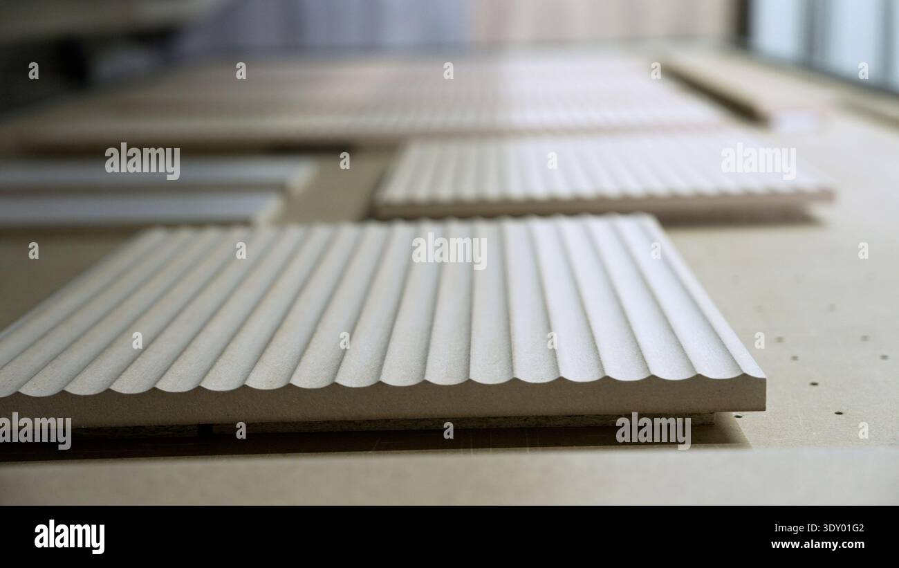 Milled MDF wood panels with fluted texture on a CNC machine in a ...