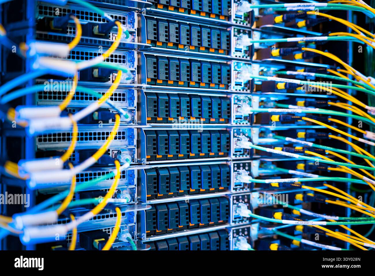 Plug In Computing close up of server racks in a data center used for ai with cables and ...