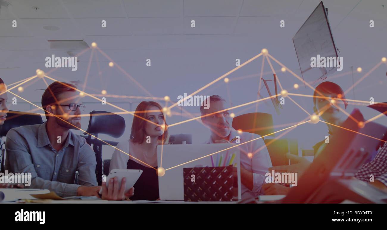 Collaborating five colleagues in business-casual using laptops in meeting room, with data overlay Stock Photo