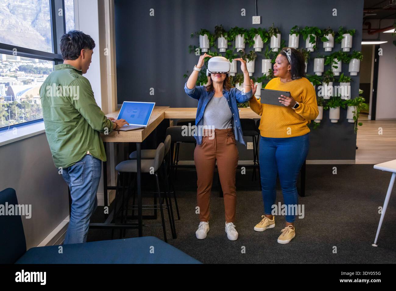 Diverse coworkers guiding woman hi-res stock photography and images - Alamy