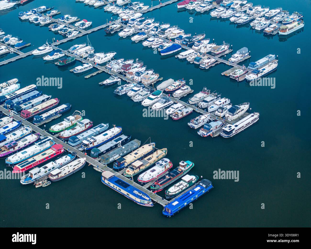Aerial view of boats docked neatly in the harbor, their white hulls ...
