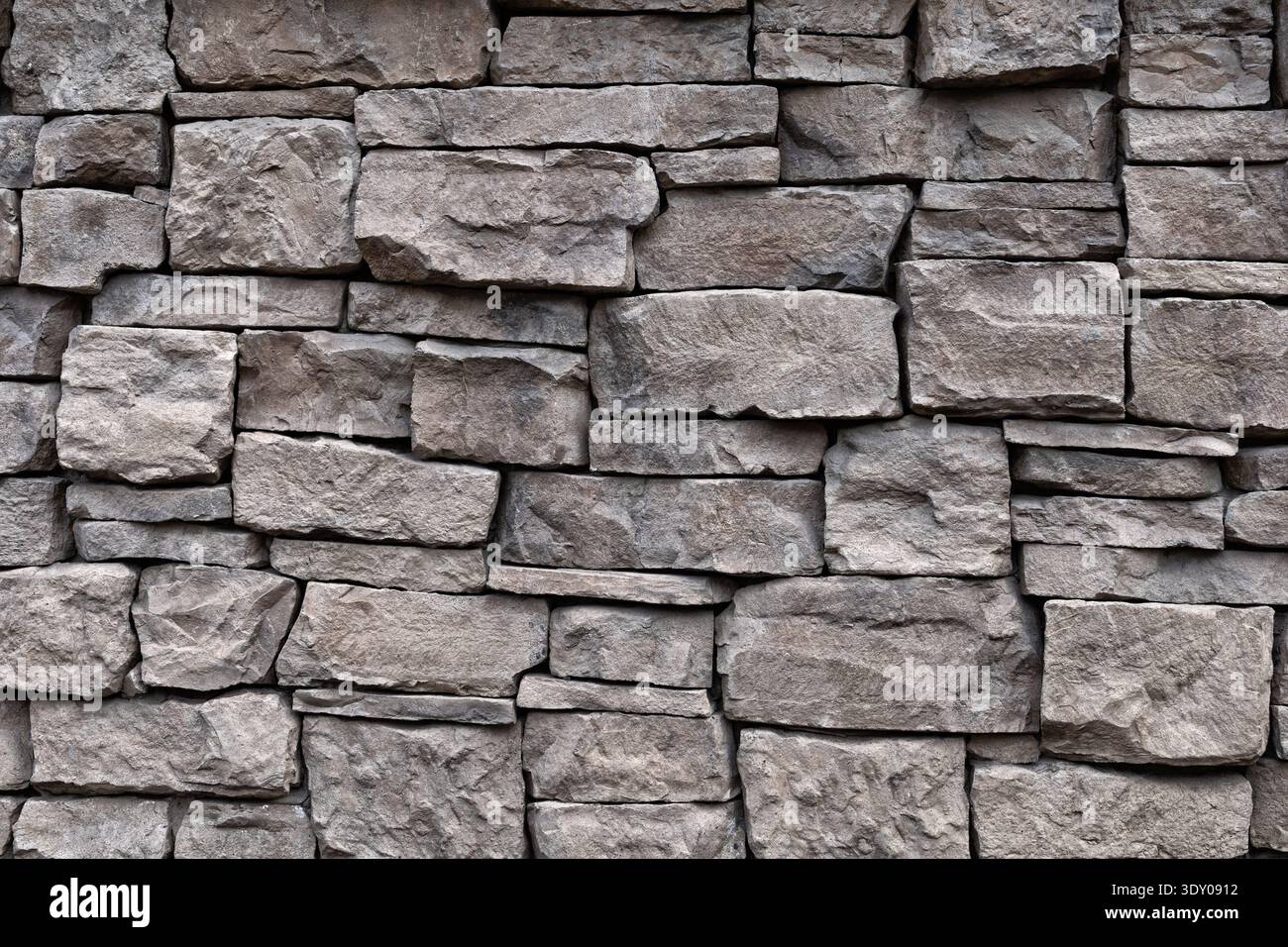 Natural stone wall texture. Rough rock masonry abstract background Stock Photo