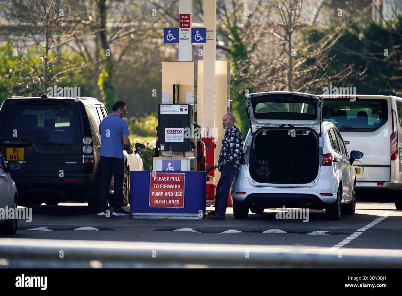 people-dispense-fuel-at-the-pump-at-costco-petrol-station-in-west