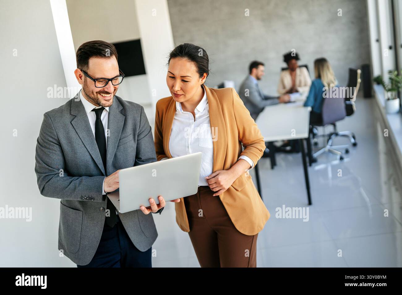 Mixed team of software engineers brainstorming ideas. Diverse app developers collaborating as group Stock Photo
