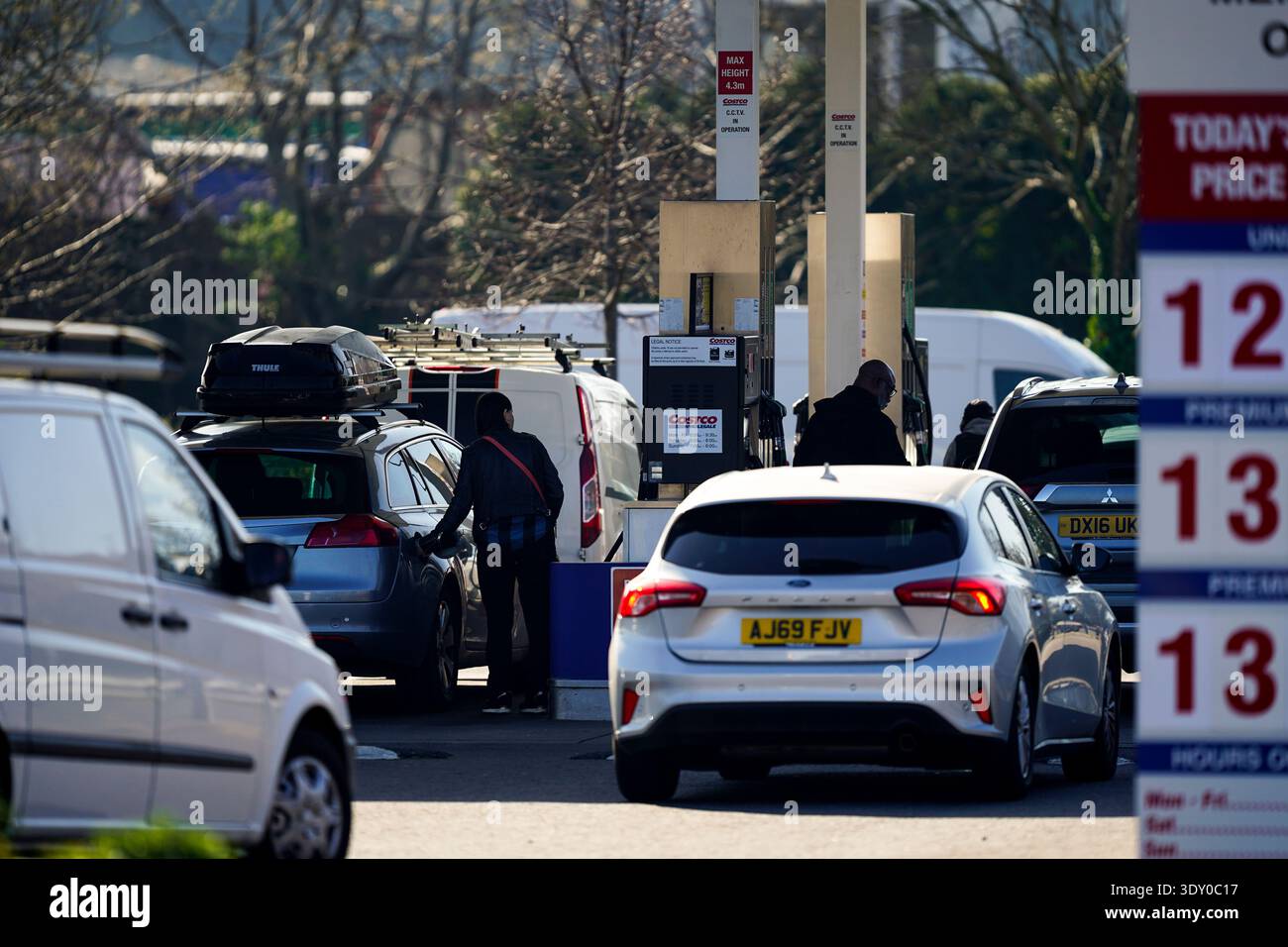 people-dispense-fuel-at-the-pump-at-costco-petrol-station-in-west