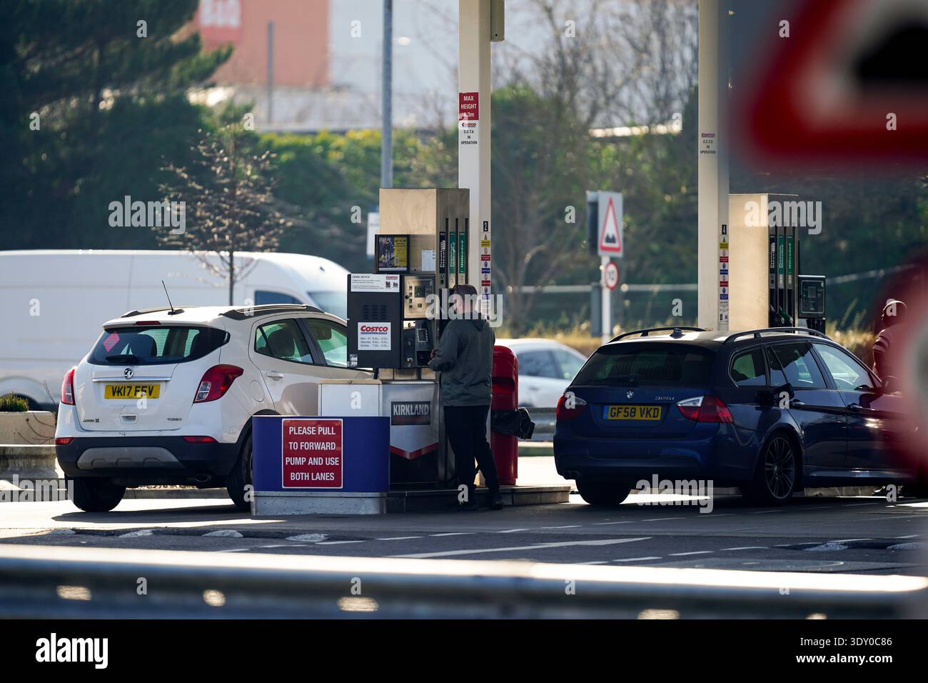 people-dispense-fuel-at-the-pump-at-costco-petrol-station-in-west