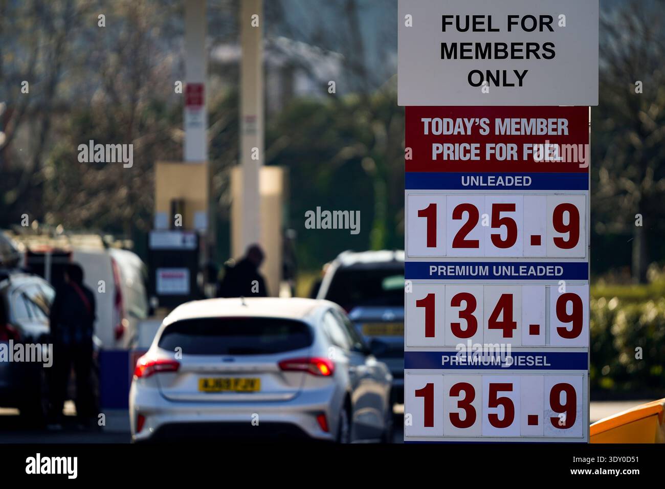 people-dispense-fuel-at-the-pump-at-costco-petrol-station-in-west